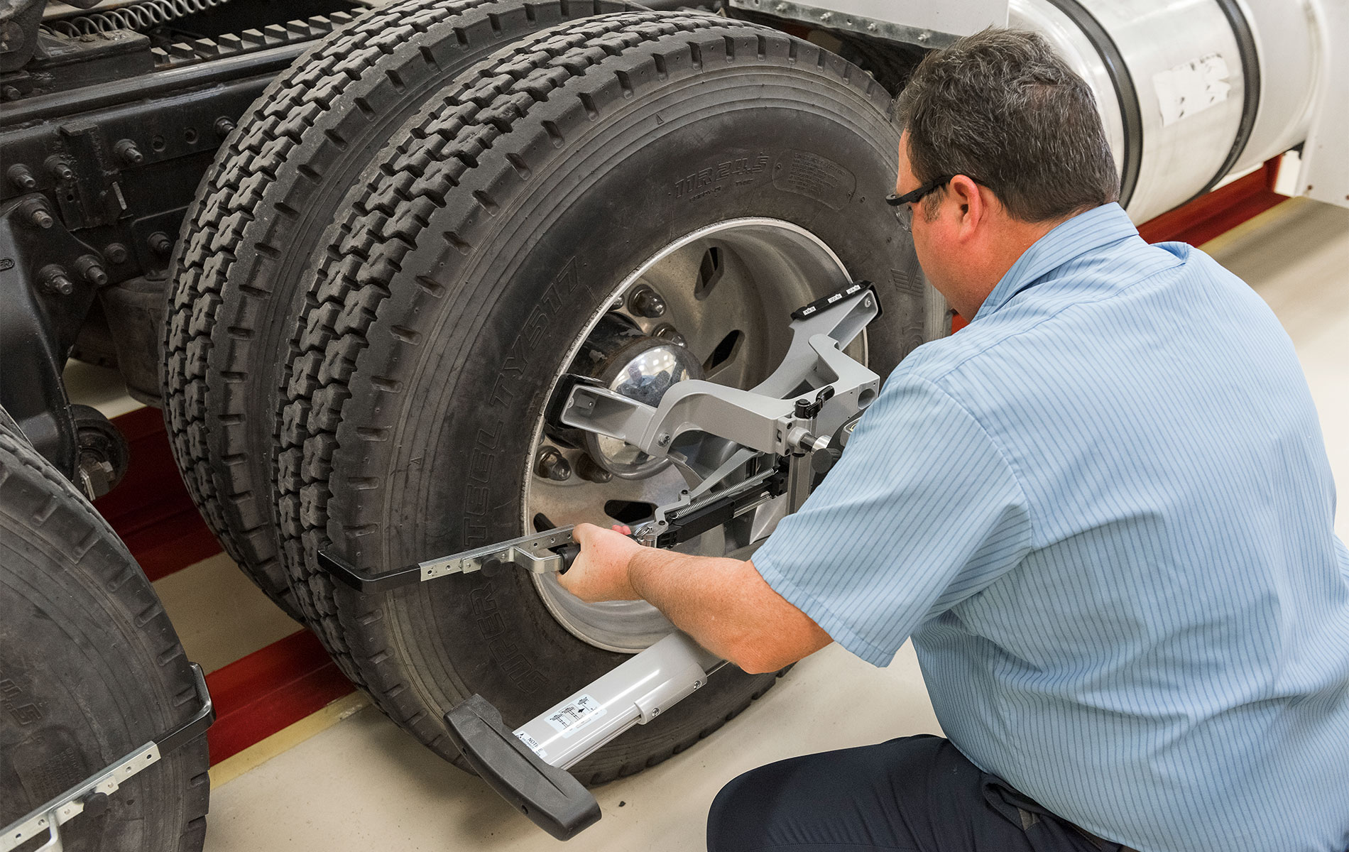 Man attaches Hunter HD QuickGrip® on tires of a semi